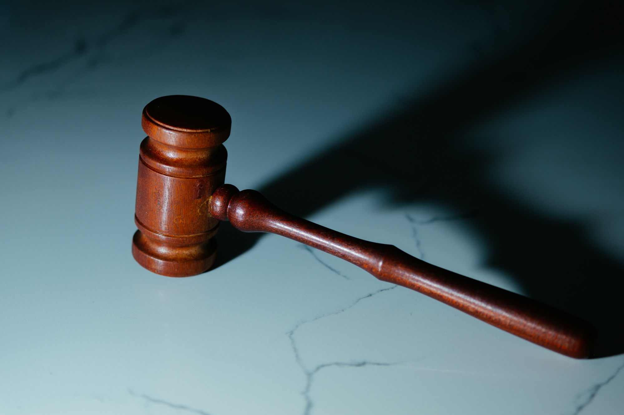 a-wooden-judge-s-hammer-sitting-on-top-of-a-table.jpg a wooden judge's hammer sitting on top of a table